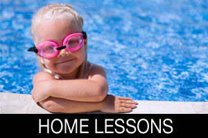 young boy with goggles on in home pool