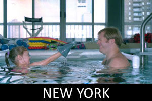 father and daughter swimming in pool in new york