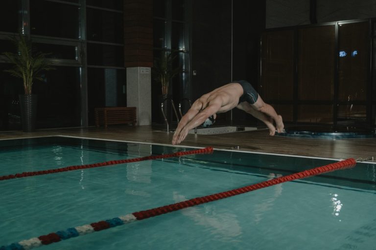 swimmer jumping into pool