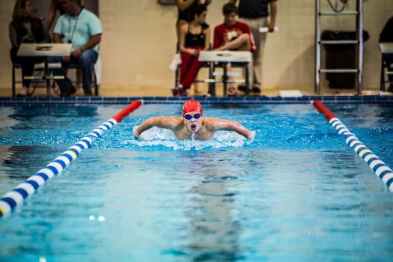 red cap swimmer in pool