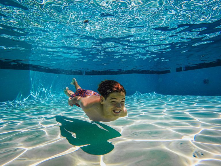 boy swimming under water