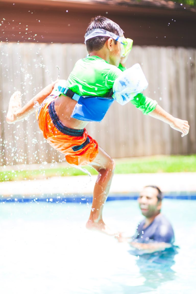 kid jumping into pool