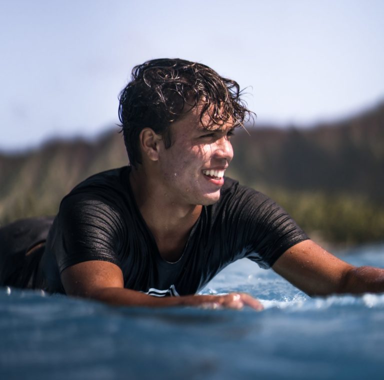 teenager on surfboard in ocean